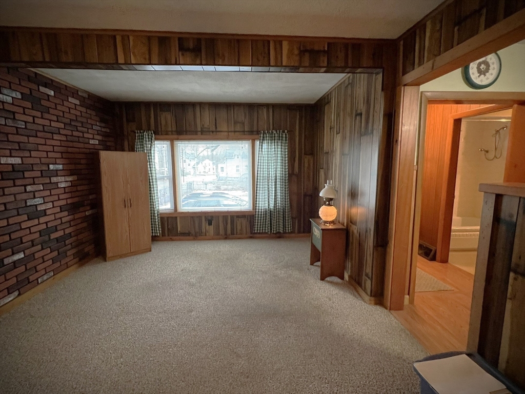 18 Eastern Avenue Webster, MA 01570 - Photo 16 of 36 a view of a hallway to a livingroom with furniture and windows