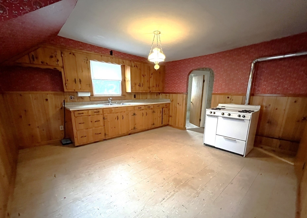 18 Eastern Avenue Webster, MA 01570 - Photo 23 of 36 a kitchen with stainless steel appliances granite countertop a stove a sink and a refrigerator