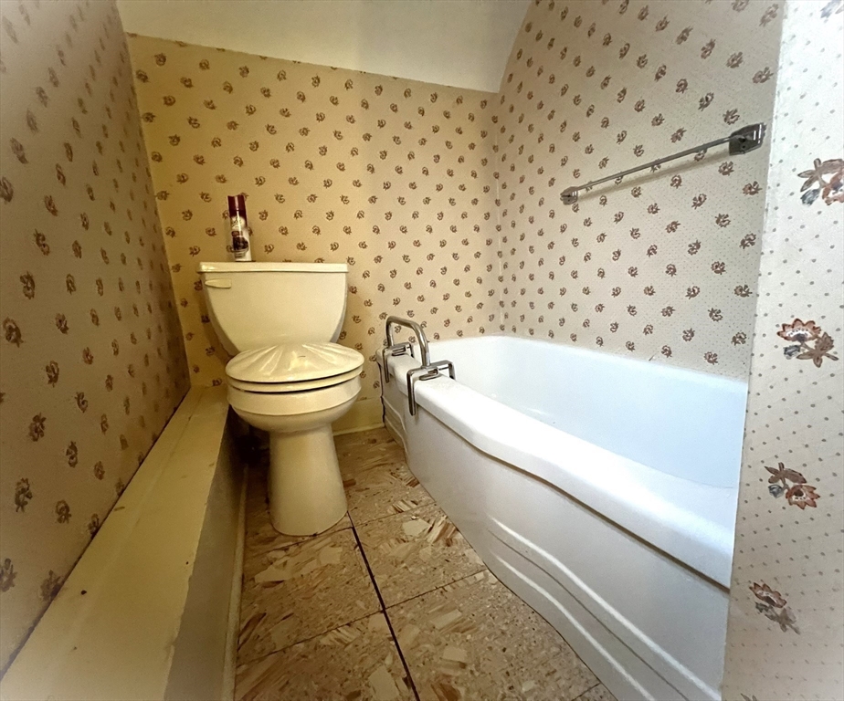 18 Eastern Avenue Webster, MA 01570 - Photo 29 of 36 a bathroom with a toilet and a shower curtain