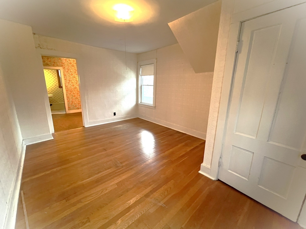 18 Eastern Avenue Webster, MA 01570 - Photo 30 of 36 a view of an empty room with wooden floor and a window