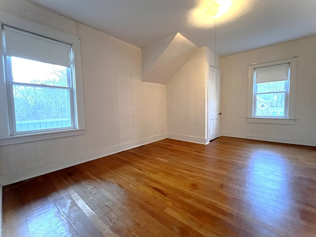 18 Eastern Avenue Webster, MA 01570 - Photo 31 of 36 an empty room with wooden floor and windows