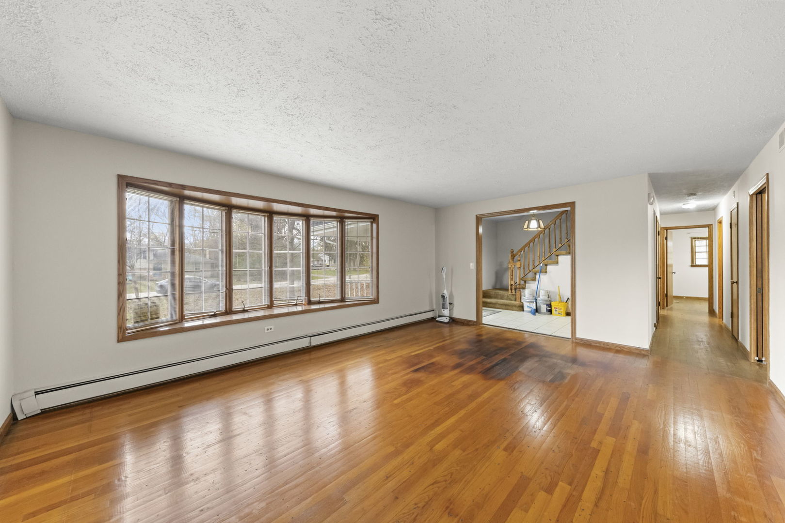 4104 Sunset Road Matteson, IL 60443 - Photo 4 of 34 a view of an empty room with wooden floor and a window