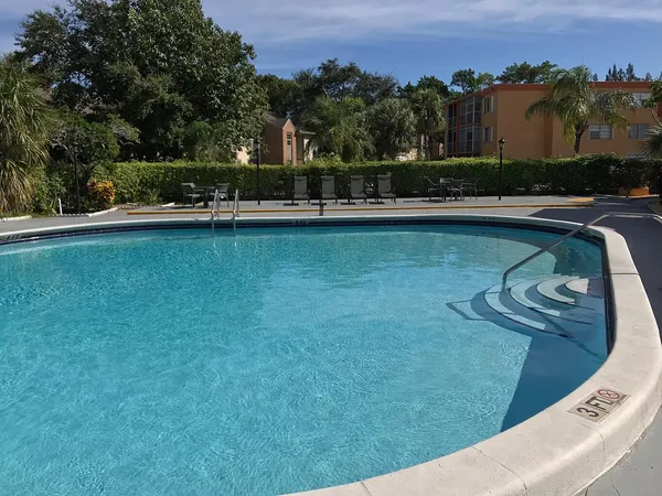 a view of a swimming pool with a yard