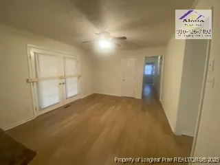 an empty room with wooden floor