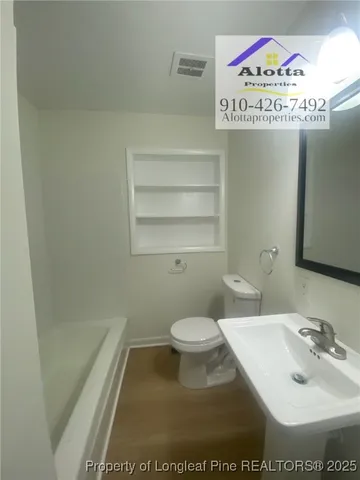 a bathroom with a toilet and a sink