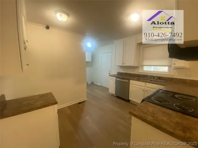 a kitchen with stainless steel appliances a stove a sink and a refrigerator