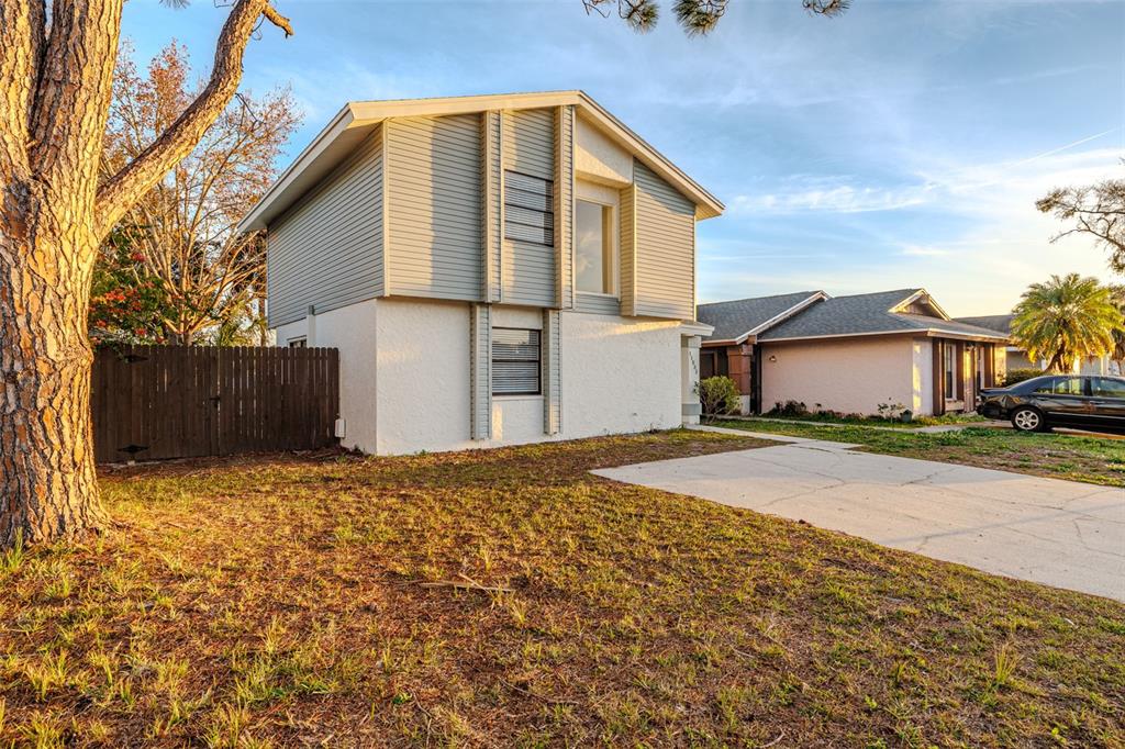 11033 Springridge Drive Tampa, FL 33624 - Photo 21 of 33 a front view of a house with a yard
