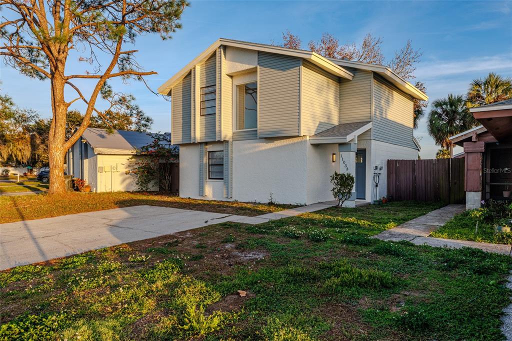 11033 Springridge Drive Tampa, FL 33624 - Photo 23 of 33 a front view of a house with a yard and garage