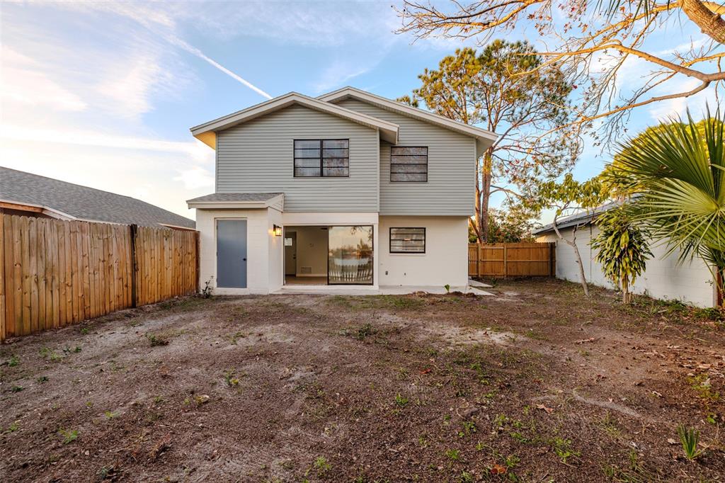 11033 Springridge Drive Tampa, FL 33624 - Photo 32 of 33 a front view of a house with a yard and garage