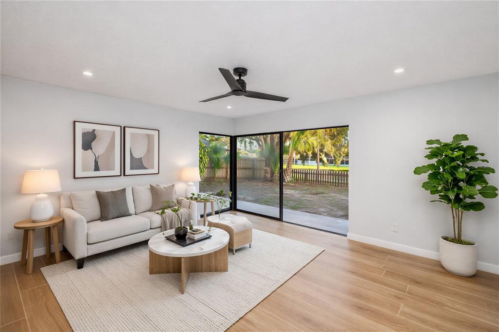 11033 Springridge Drive Tampa, FL 33624 - Photo 4 of 33 a living room with furniture and a large window