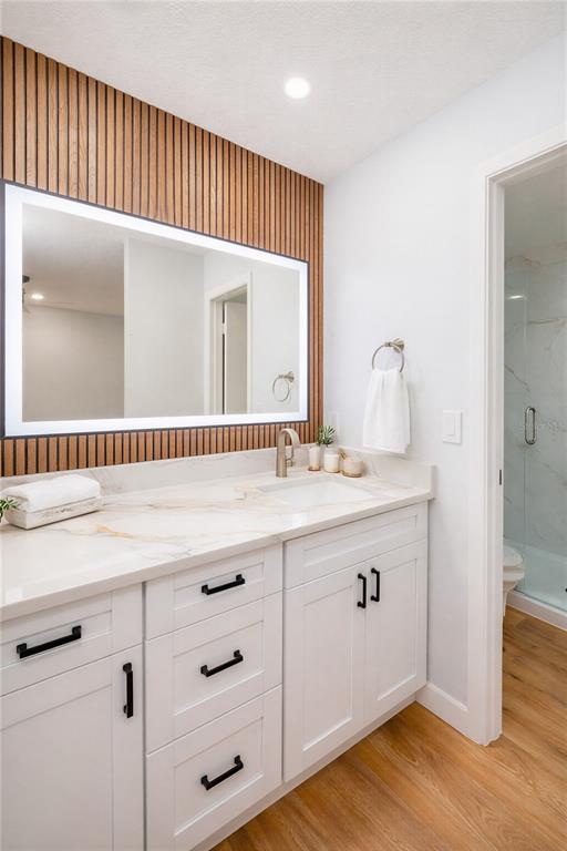 11033 Springridge Drive Tampa, FL 33624 - Photo 7 of 33 a bathroom with a sink a mirror and wooden floors