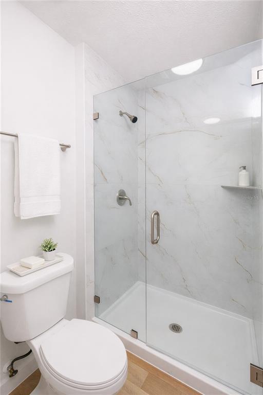 11033 Springridge Drive Tampa, FL 33624 - Photo 8 of 33 a white toilet and shower sitting next to a bathroom sink