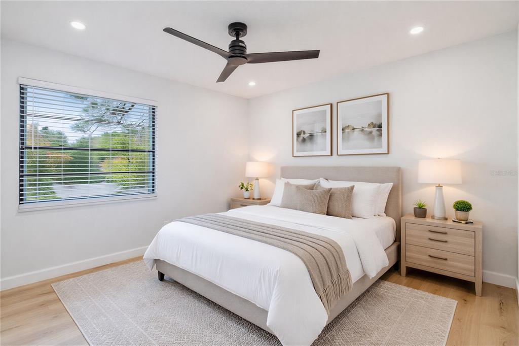 11033 Springridge Drive Tampa, FL 33624 - Photo 9 of 33 a bedroom with a bed a ceiling fan and a window