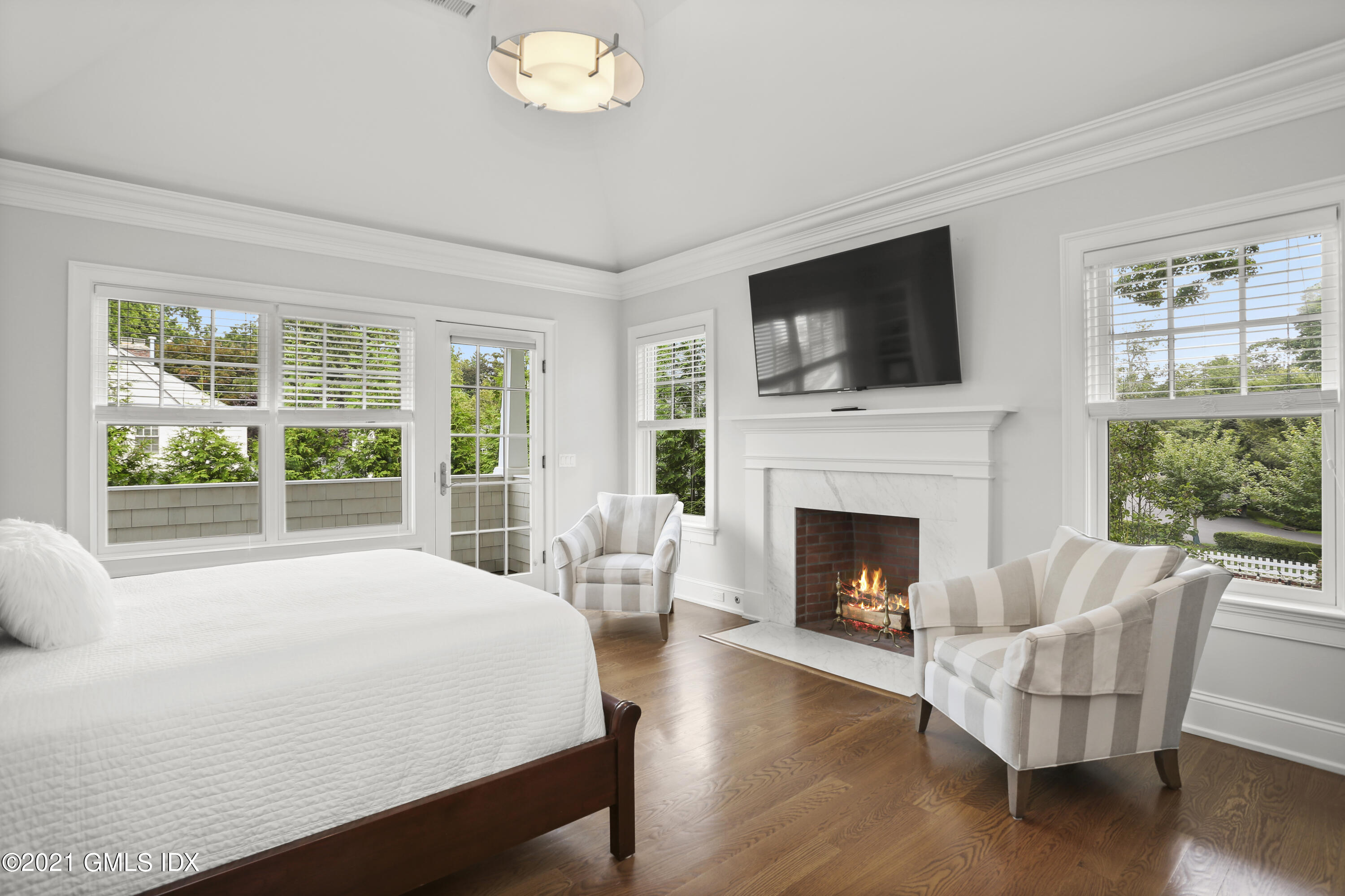 15 Terrace Avenue Riverside, CT 06878 - Photo 16 of 27 a bed sitting in a living room with furniture and a fireplace