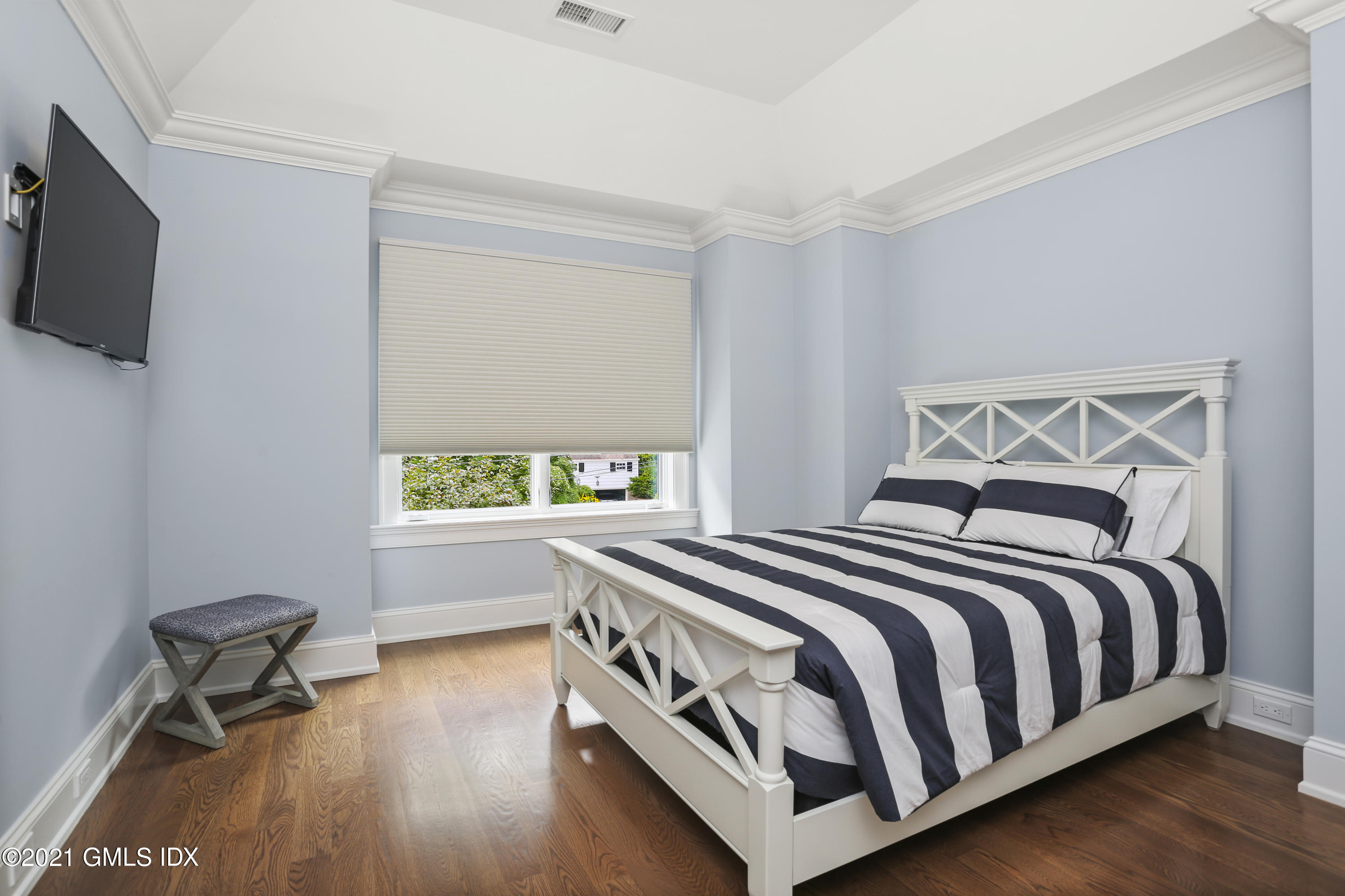 15 Terrace Avenue Riverside, CT 06878 - Photo 19 of 27 a bedroom with a bed and a flat tv screen on the dresser