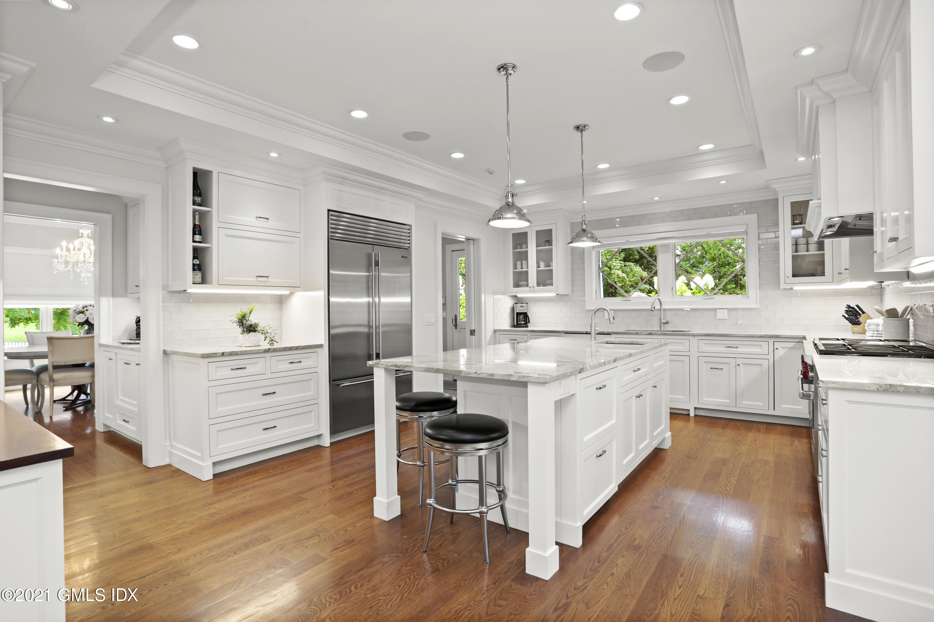 15 Terrace Avenue Riverside, CT 06878 - Photo 3 of 27 a large kitchen with kitchen island white cabinets and stainless steel appliances