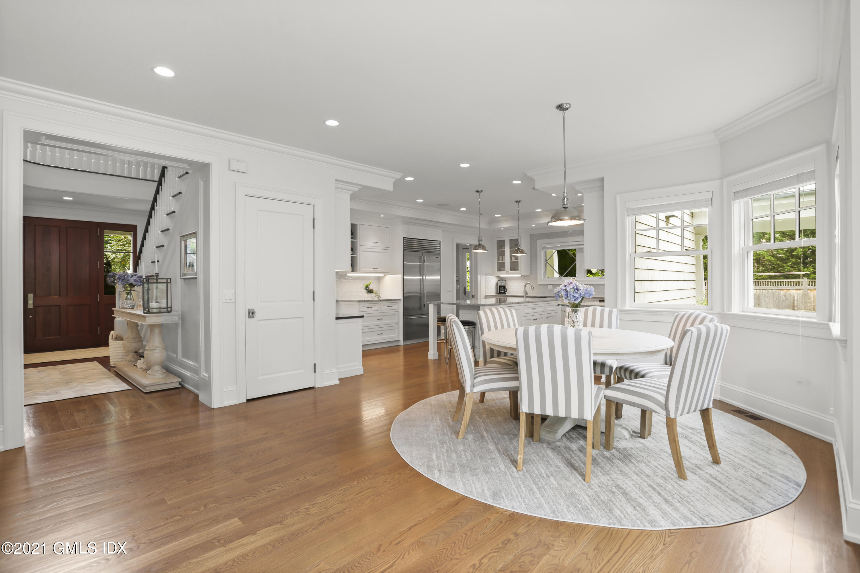 15 Terrace Avenue Riverside, CT 06878 - Photo 6 of 27 a dining room with wooden floor a glass table and chairs