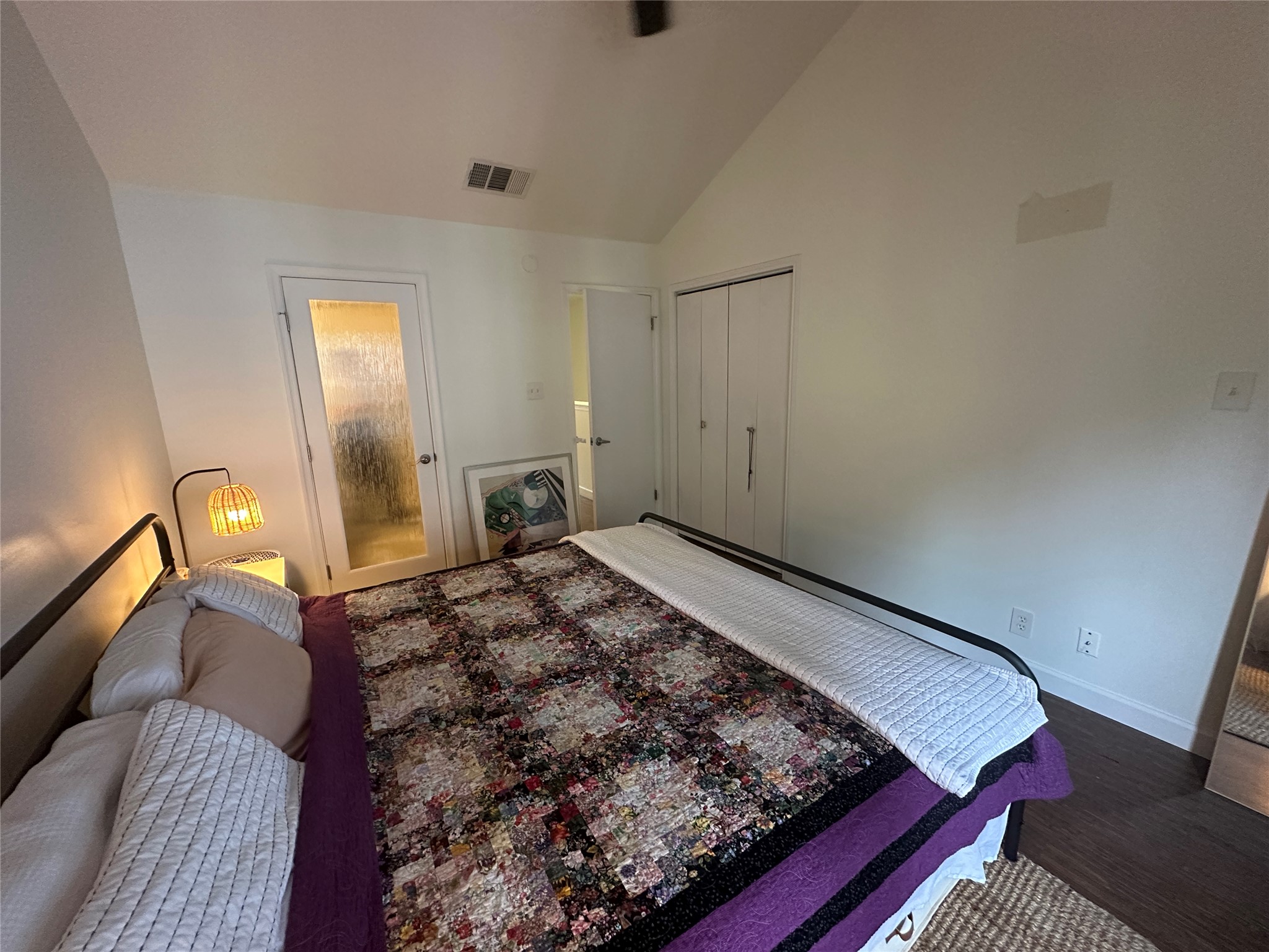 2215 Post Road, Unit 2002 Austin, TX 78704 - Photo 6 of 12 a bedroom with a bed and wooden floor