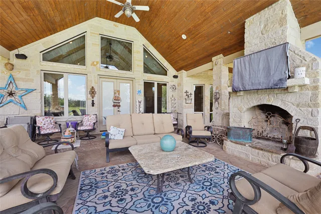 a living room with furniture a fireplace and potted plants