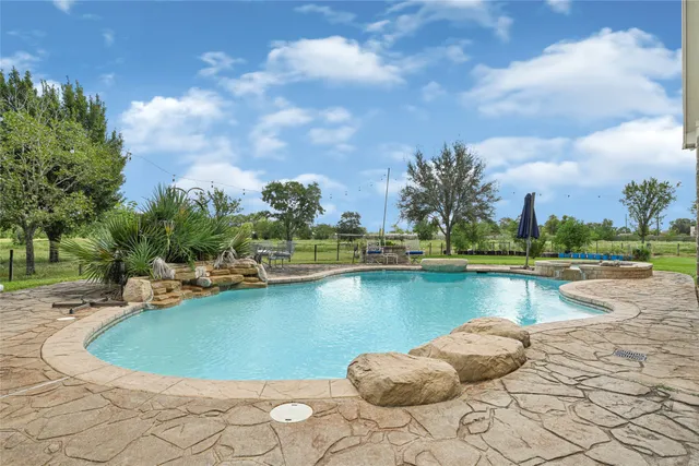 a view of a swimming pool next to a lake with houses