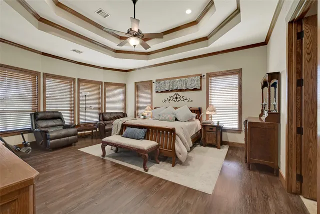 a bedroom with furniture and a large window