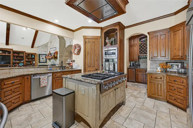 a kitchen with stainless steel appliances granite countertop a stove and a sink