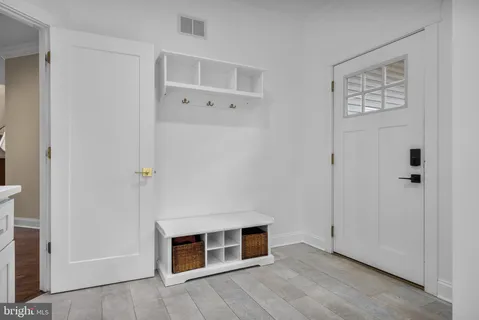 a view of a livingroom with an empty space and wooden floor