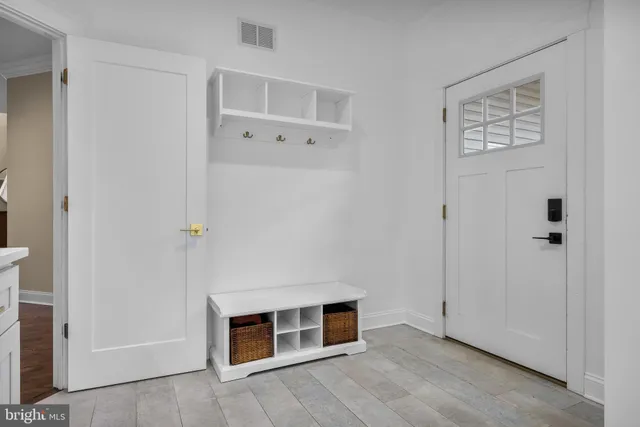 a view of a livingroom with an empty space and wooden floor