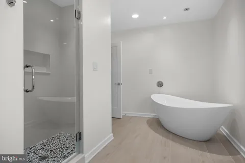 a bathroom with a bathtub and shower