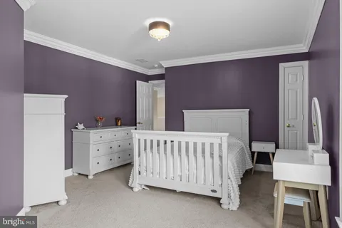 a bed room with a bed and a chair