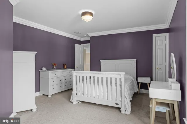 a bed room with a bed and a chair