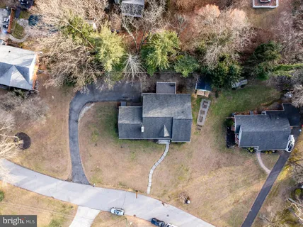 an aerial view of a house with garden space and a patio