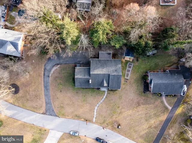 an aerial view of a house with garden space and a patio
