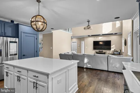 a very nice looking living room with a large window and a clock