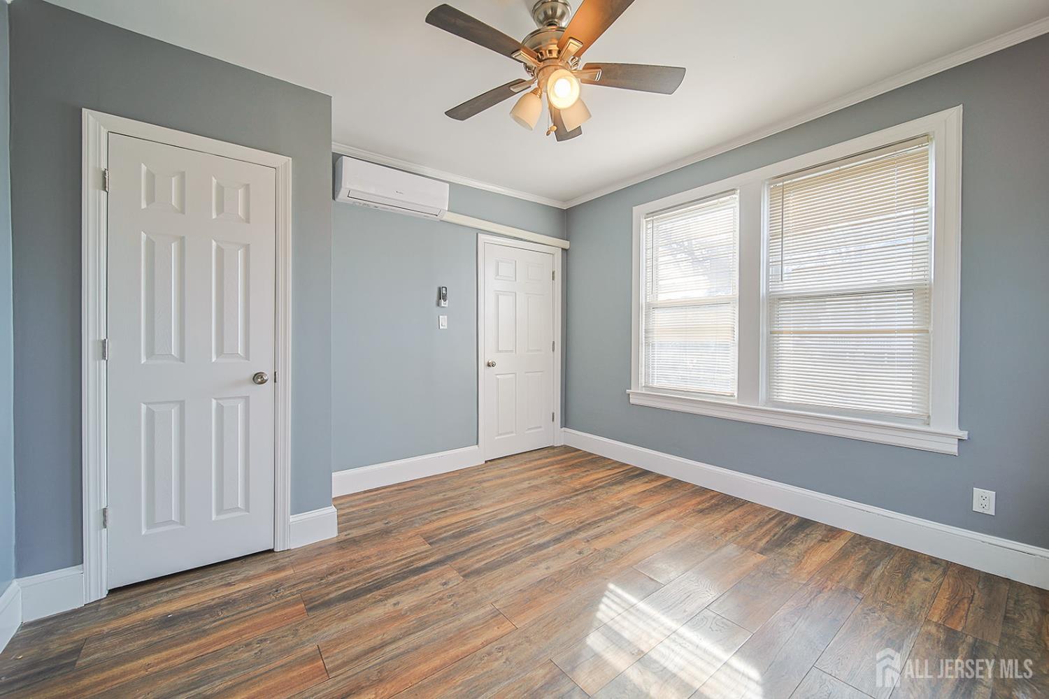 9 Rolfe Avenue Highland Park, NJ 08904 - Photo 4 of 8 a view of an empty room with wooden floor and a window