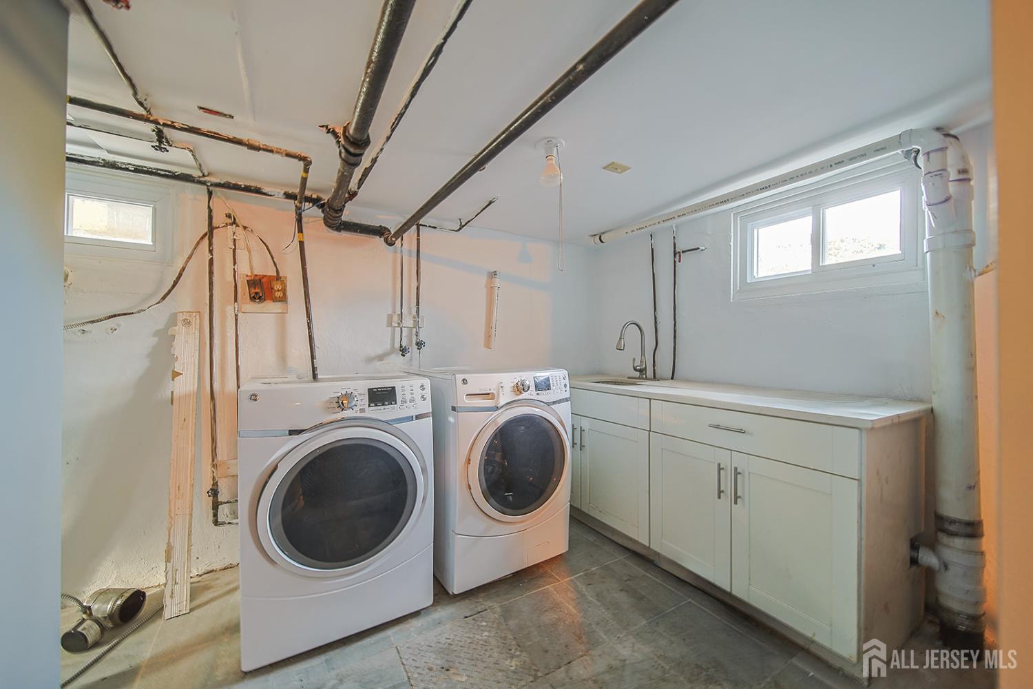 9 Rolfe Avenue Highland Park, NJ 08904 - Photo 6 of 8 a utility room with dryer and washer