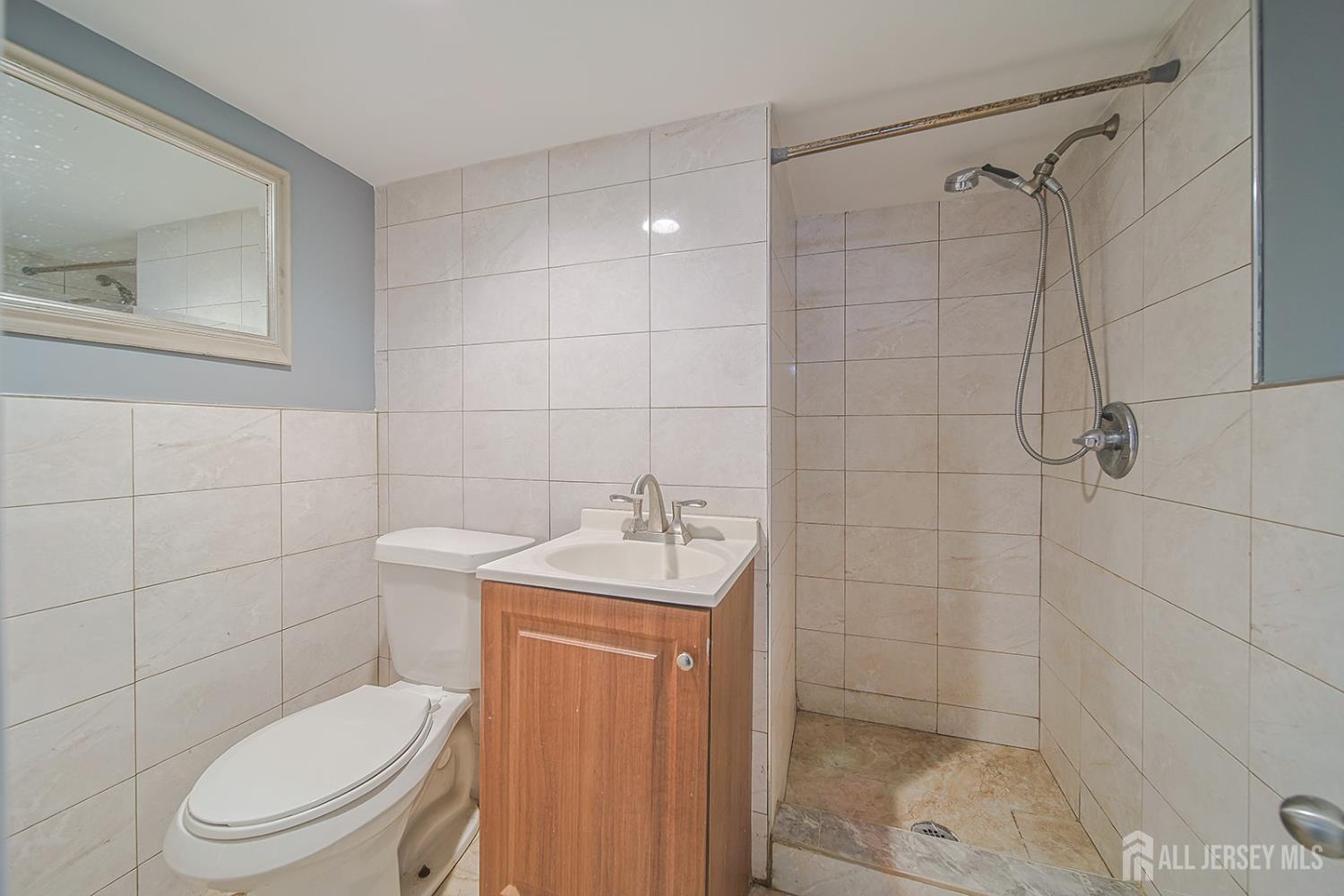 9 Rolfe Avenue Highland Park, NJ 08904 - Photo 8 of 8 a bathroom with a toilet a sink and shower