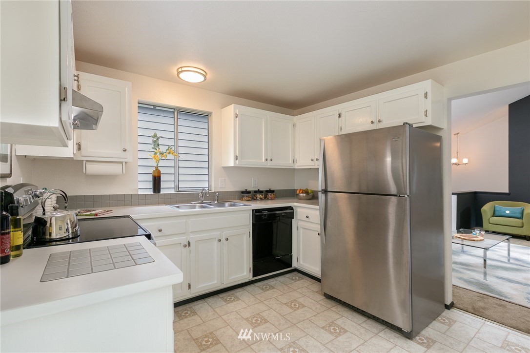 741 North 87th Street Seattle, WA 98103 - Photo 12 of 20 a kitchen with a refrigerator sink and cabinets