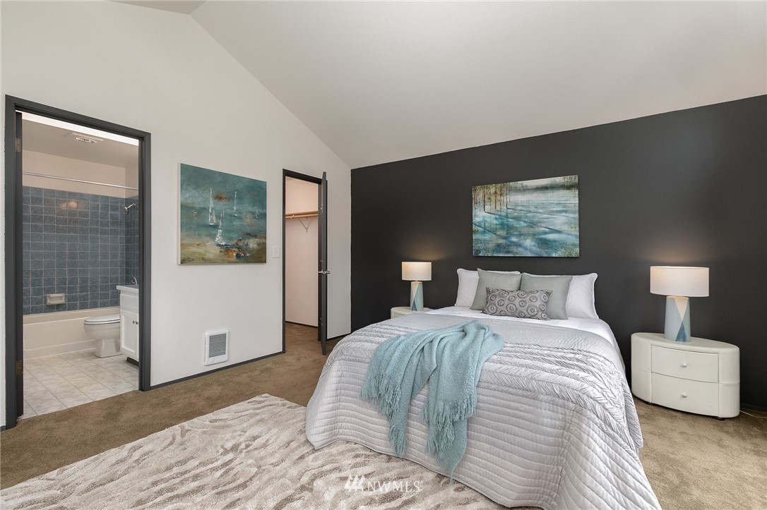 741 North 87th Street Seattle, WA 98103 - Photo 15 of 20 a bedroom with a large bed and a night stand