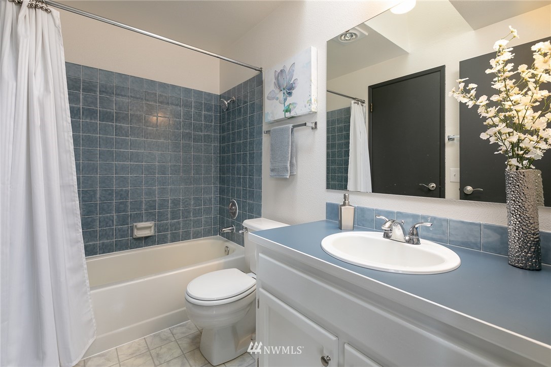 741 North 87th Street Seattle, WA 98103 - Photo 16 of 20 a bathroom with a sink toilet and shower