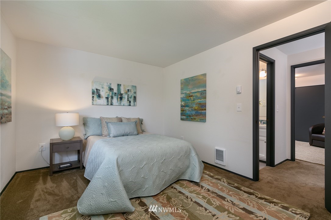 741 North 87th Street Seattle, WA 98103 - Photo 18 of 20 a bedroom with a bed and a painting on the wall