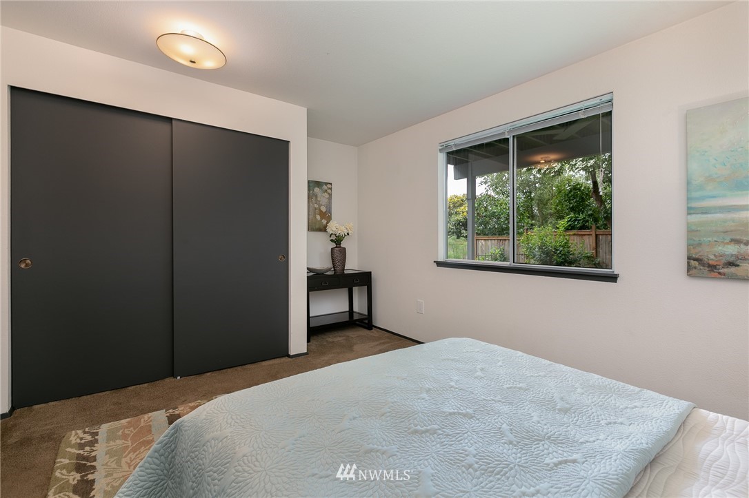 741 North 87th Street Seattle, WA 98103 - Photo 19 of 20 a bedroom with a bed and a window