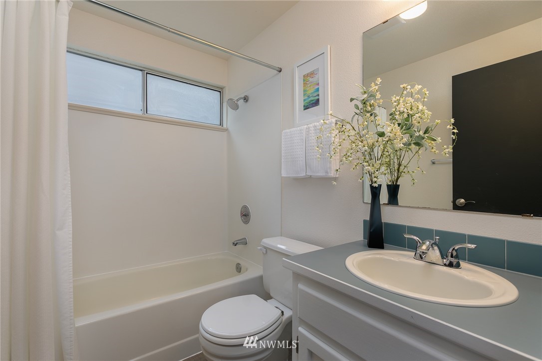 741 North 87th Street Seattle, WA 98103 - Photo 20 of 20 a bathroom with a sink a toilet a tub and shower
