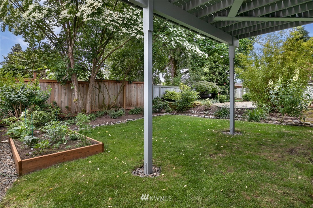 741 North 87th Street Seattle, WA 98103 - Photo 4 of 20 a view of a backyard with plants and a garden