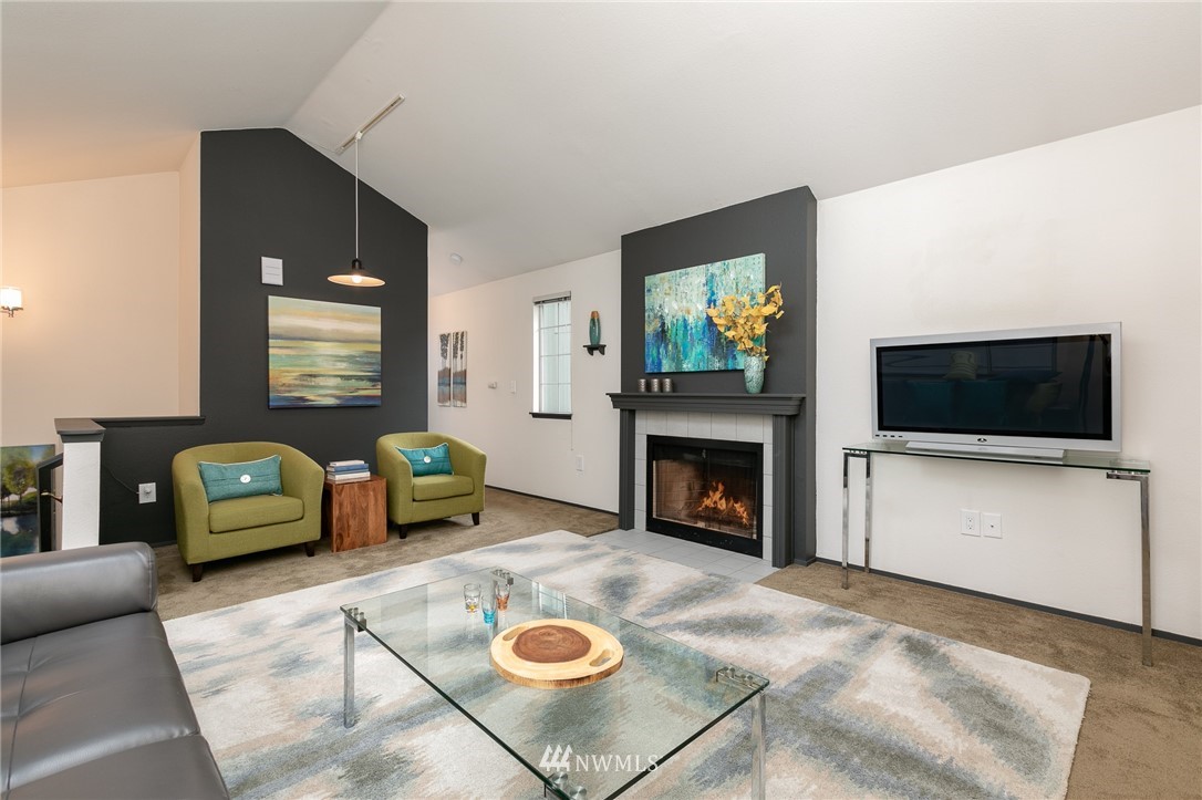 741 North 87th Street Seattle, WA 98103 - Photo 6 of 20 a living room with furniture a flat screen tv and a fireplace