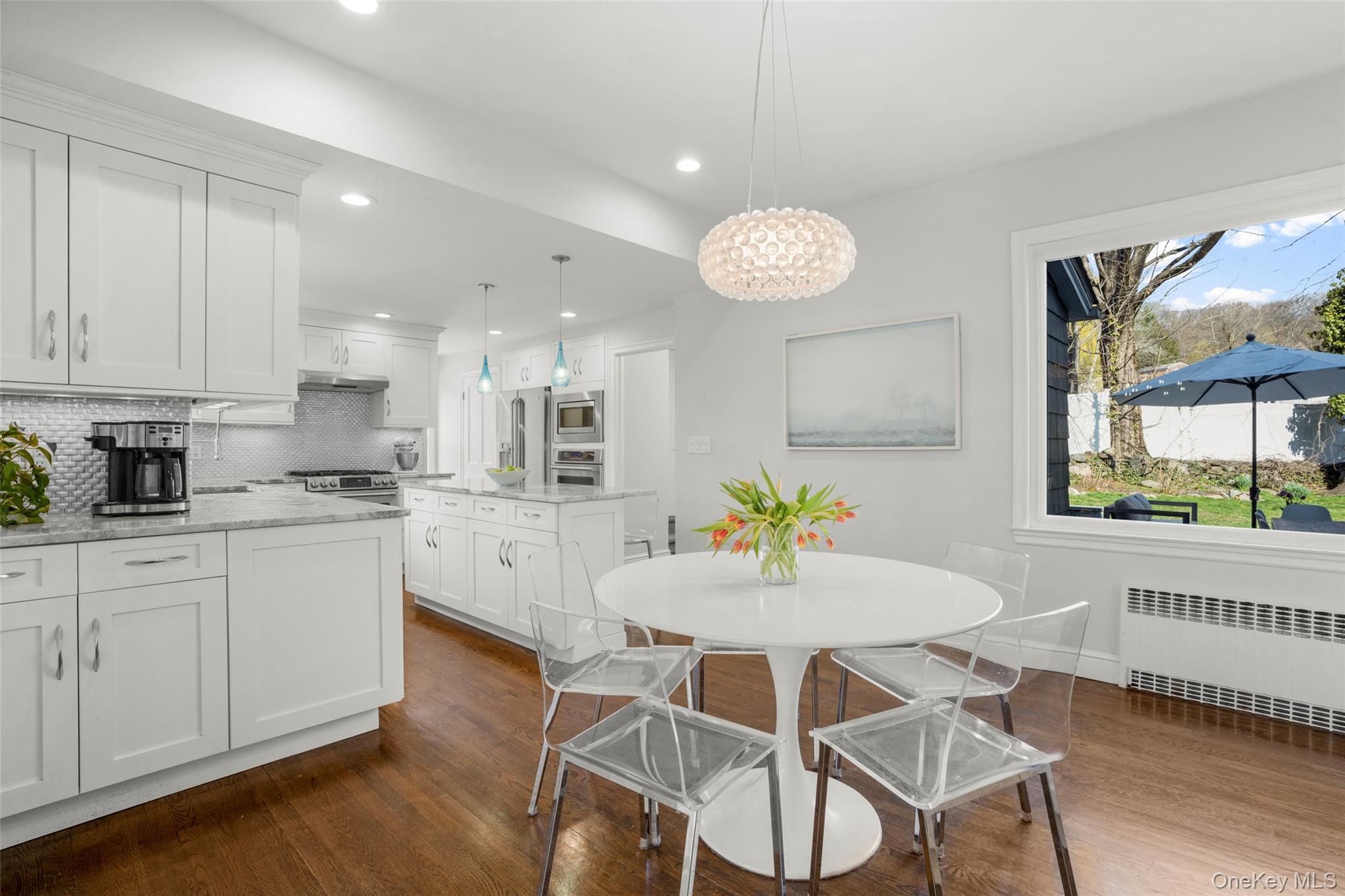 644 Fort Hill Road Scarsdale, NY 10583 - Photo 16 of 42 a kitchen with stainless steel appliances kitchen island granite countertop a table and chairs in it