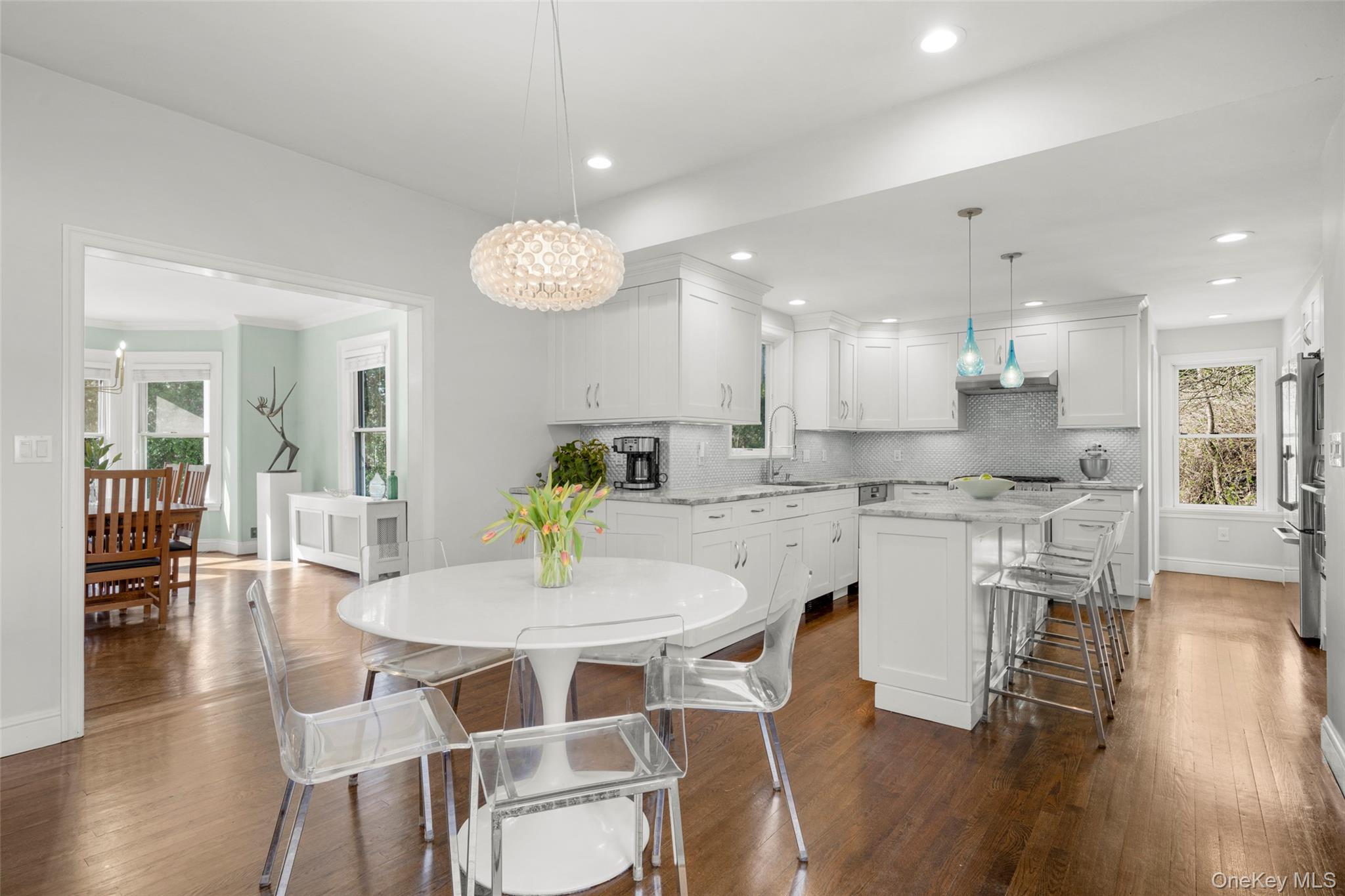 644 Fort Hill Road Scarsdale, NY 10583 - Photo 17 of 42 a kitchen with a dining table chairs and wooden floor