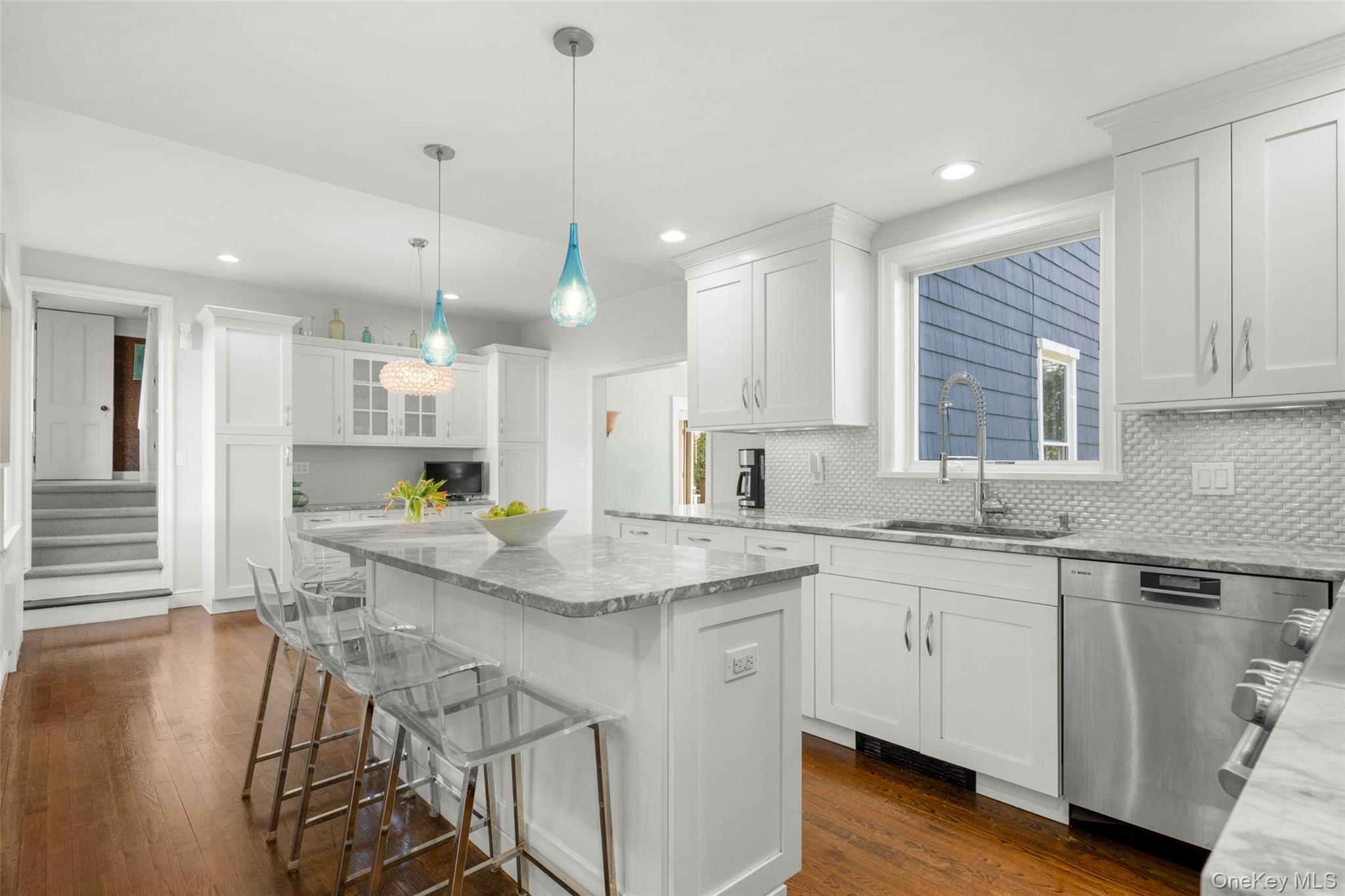 644 Fort Hill Road Scarsdale, NY 10583 - Photo 18 of 42 a kitchen with stainless steel appliances granite countertop a sink a stove a refrigerator and white cabinets with wooden floor