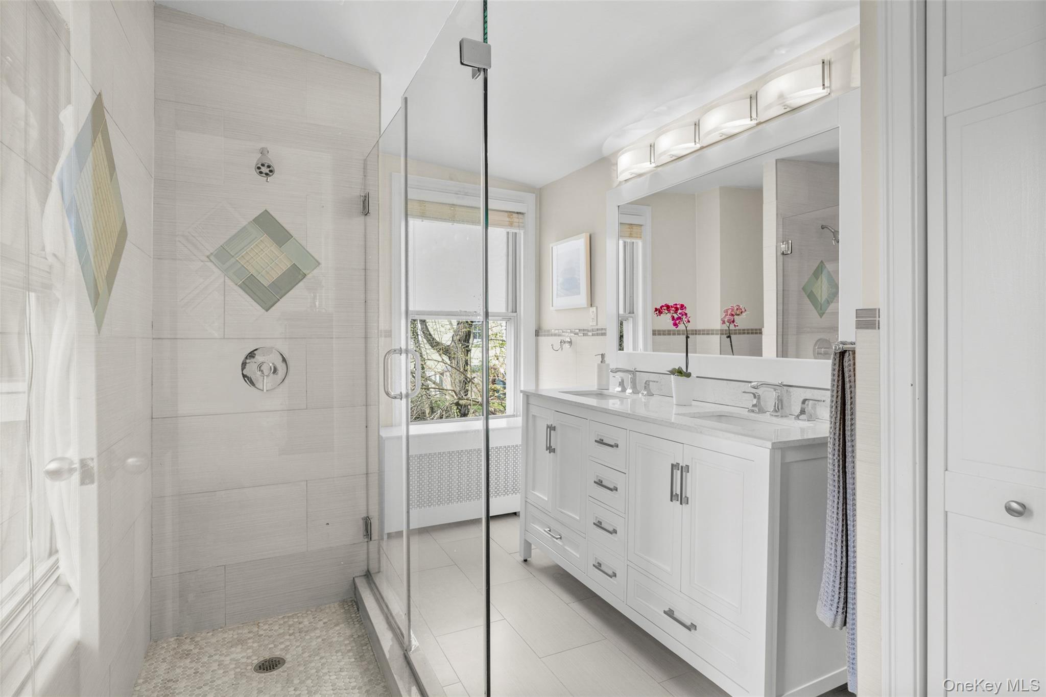 644 Fort Hill Road Scarsdale, NY 10583 - Photo 32 of 42 a bathroom with a shower sink and mirror