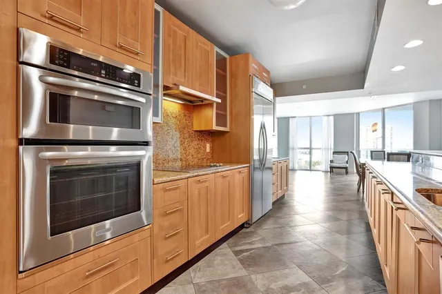 a large white kitchen with a large window